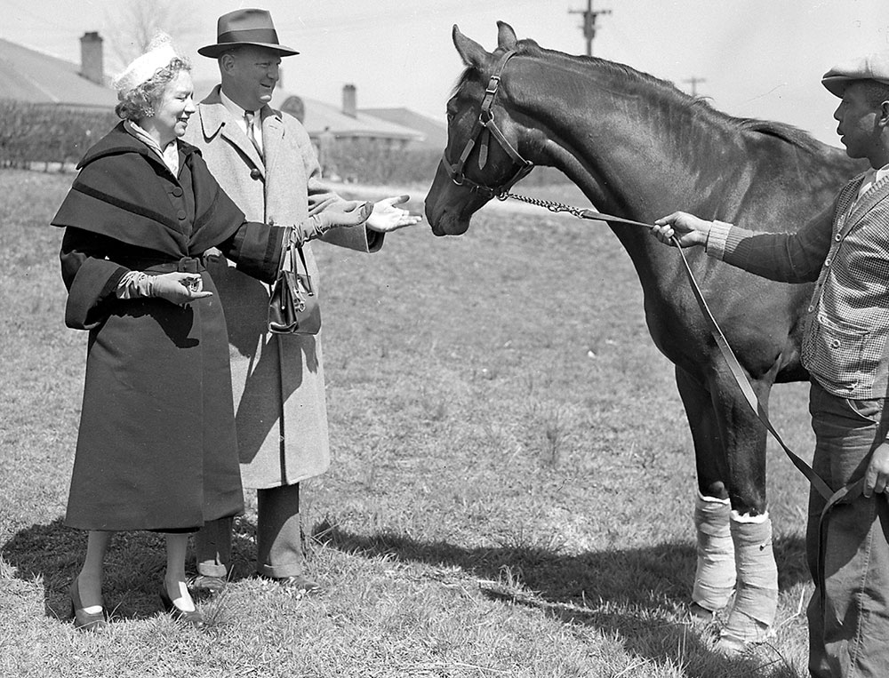 Mrs. Elizabeth Arden Graham with Leslie Combs II at Keeneland on April 7, 1950 - Keeneland Library / Meadors Photographic Collection