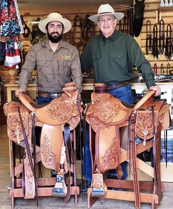 Karsten and Kent Frecker shown with a couple floral carved saddles.