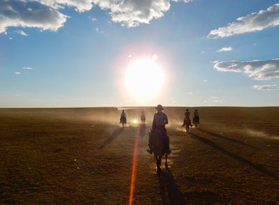 Days sometimes don't end until sunset on the Gobi Gallop  Pictured - Ryan Kertanis, Jenna Arnett, Kylie Gracie, Anita McNamara, Head Guide and Co-Owner of Horse Trek Mongolia, Batsaikhan