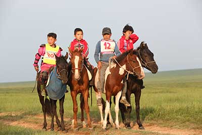 Young jockeys proudly race for the international riders. © Gobi Desert Cup