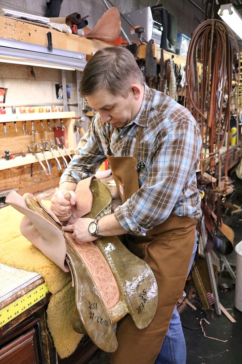 Bryan Oliver, 4th generation owner of Oliver Saddle Shop, working on a saddle