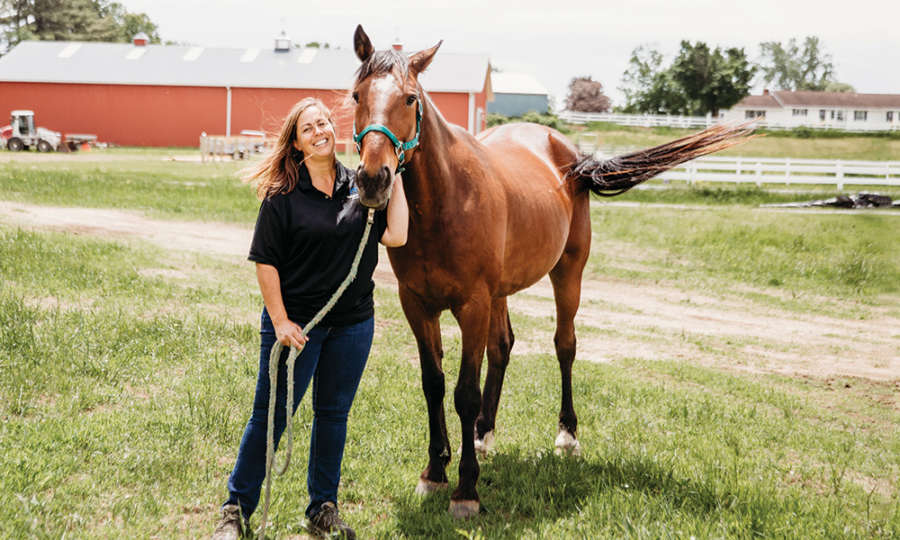 Horse owner Dr. Erin Christopher-Sisk began practicing equine-assisted therapy with two of her own racehorses after they suffered career-ending injuries. (photo courtesy of Dori Fitzpatrick)